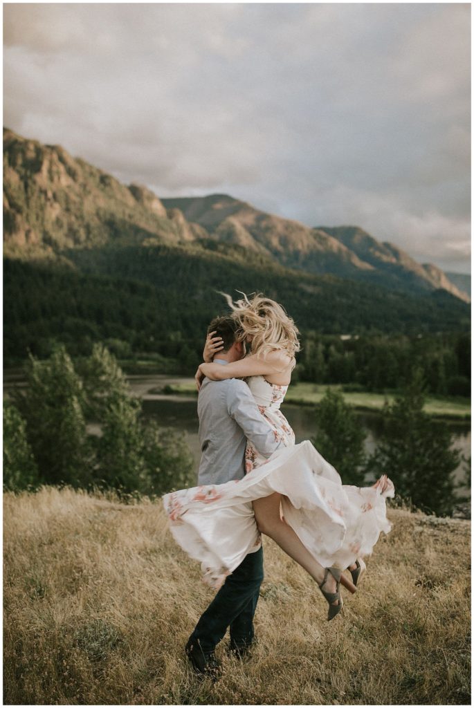 couple embracing on hillside